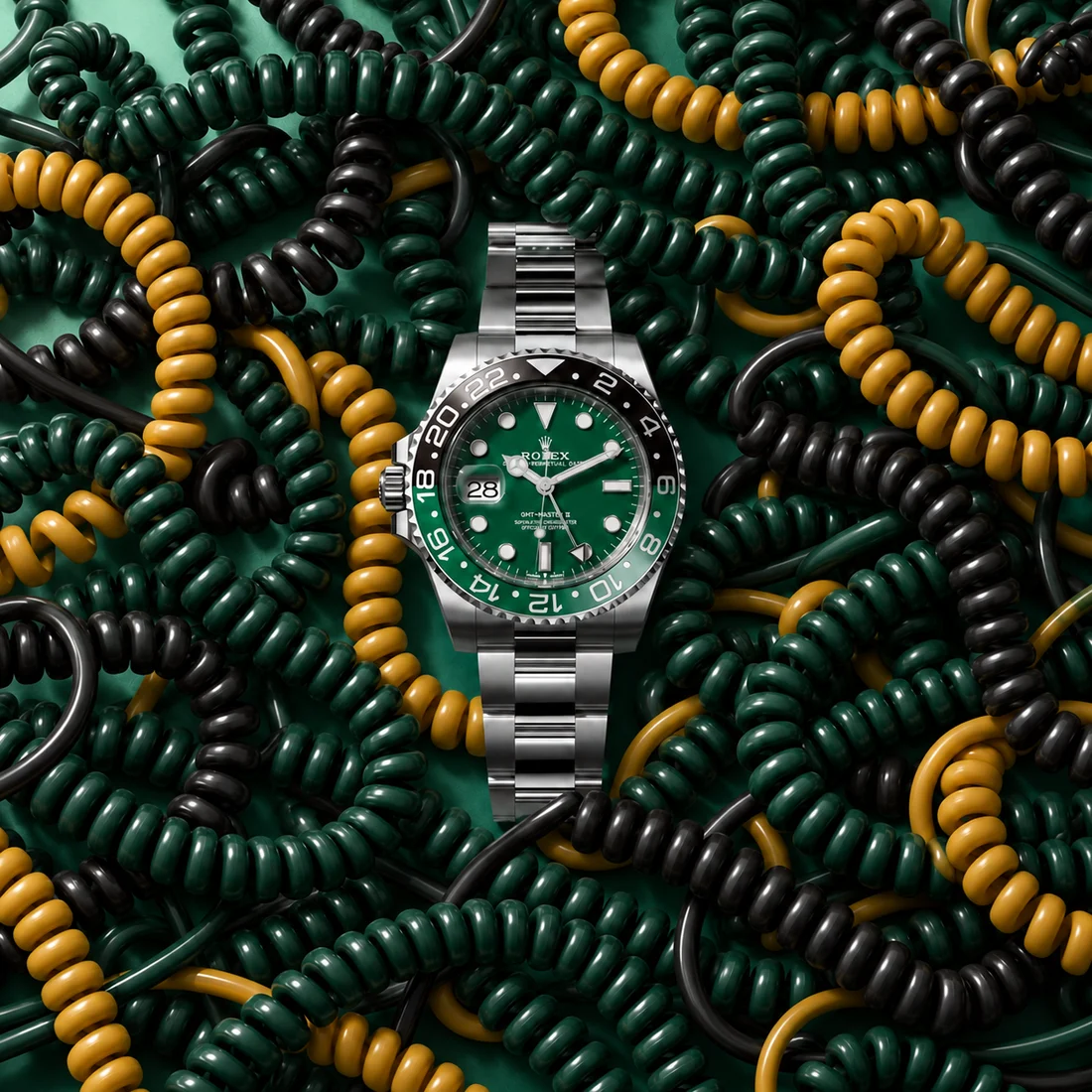 A steel watch with a green dial